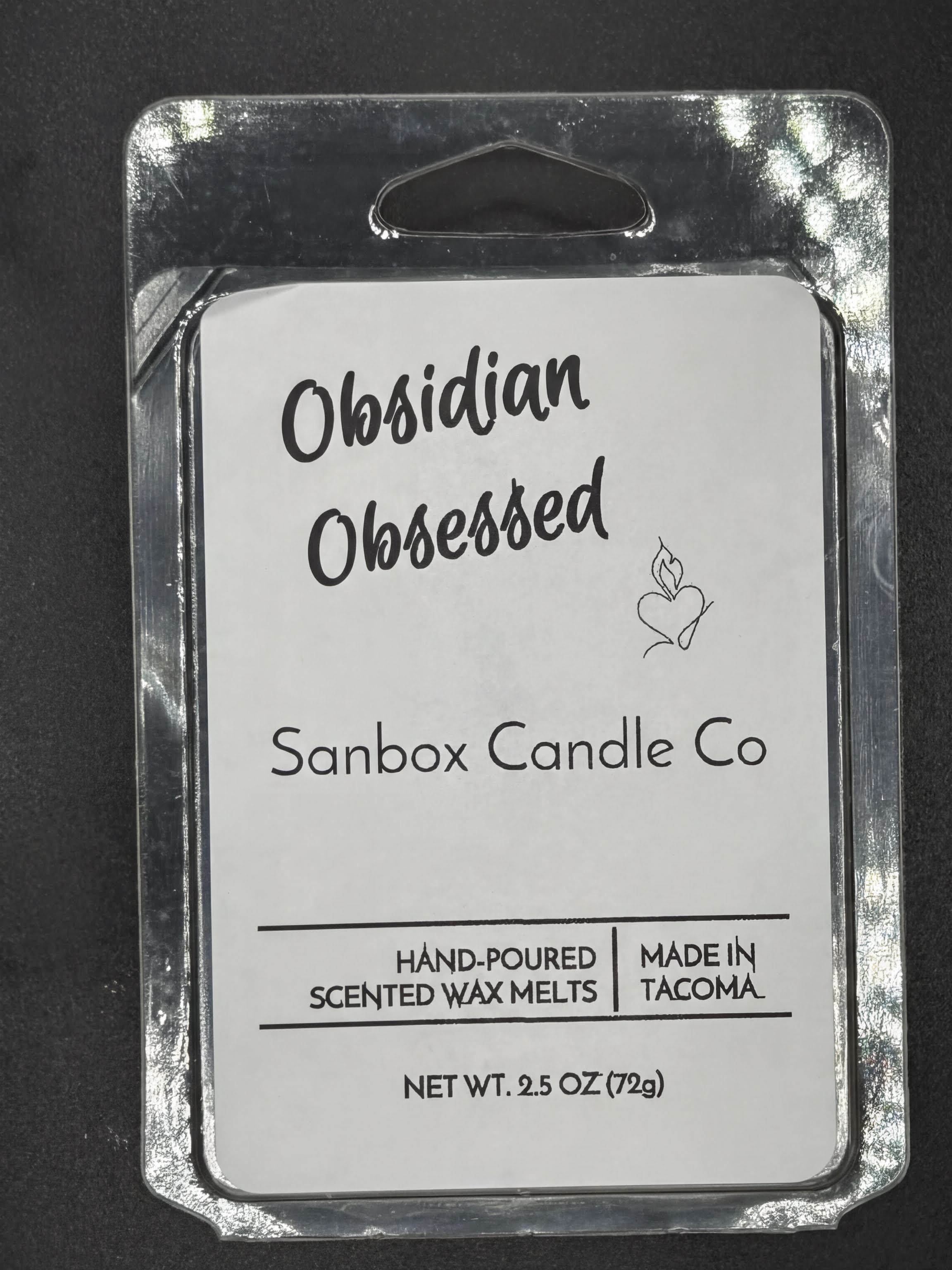 Obsidian Obsessed hand-poured scented wax melts packaging, 2.5oz, on black background
