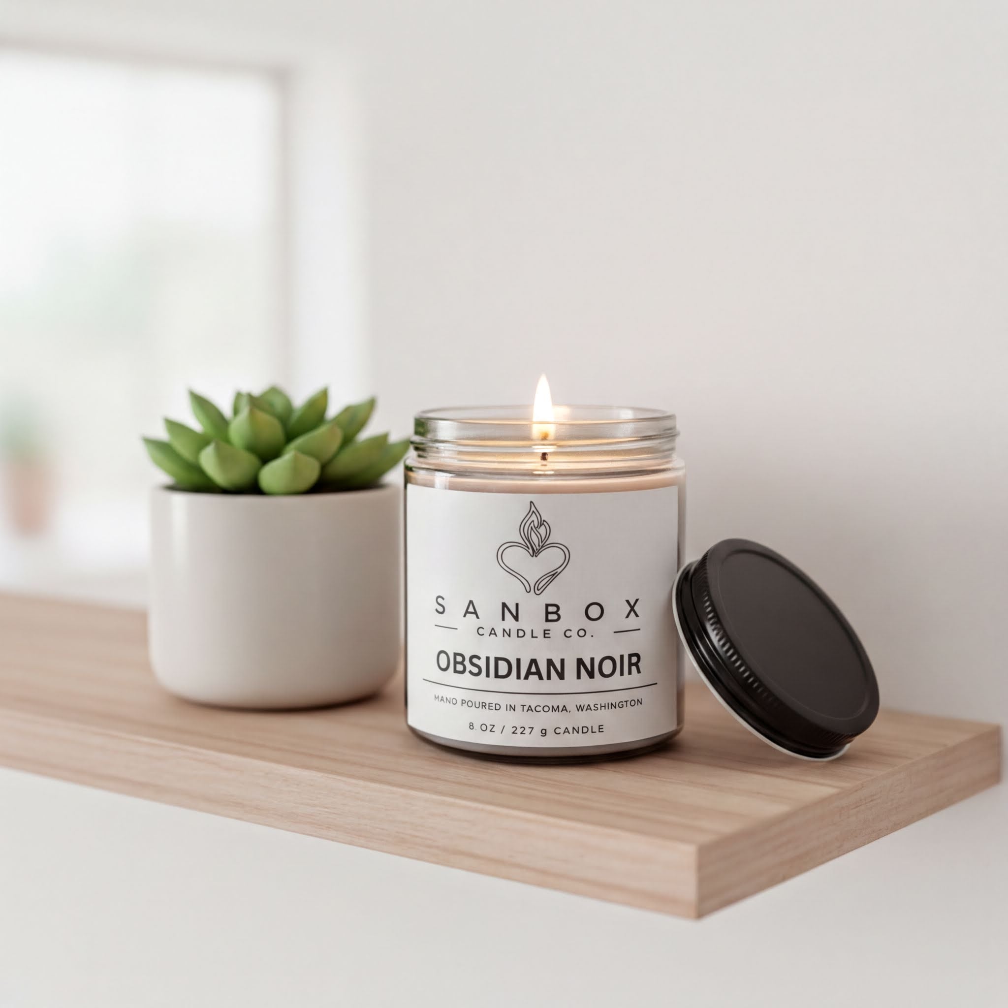 a wooden shelf with a lit candle in a jar, a potted succulent plant, and a black lid on a wooden shelf.
