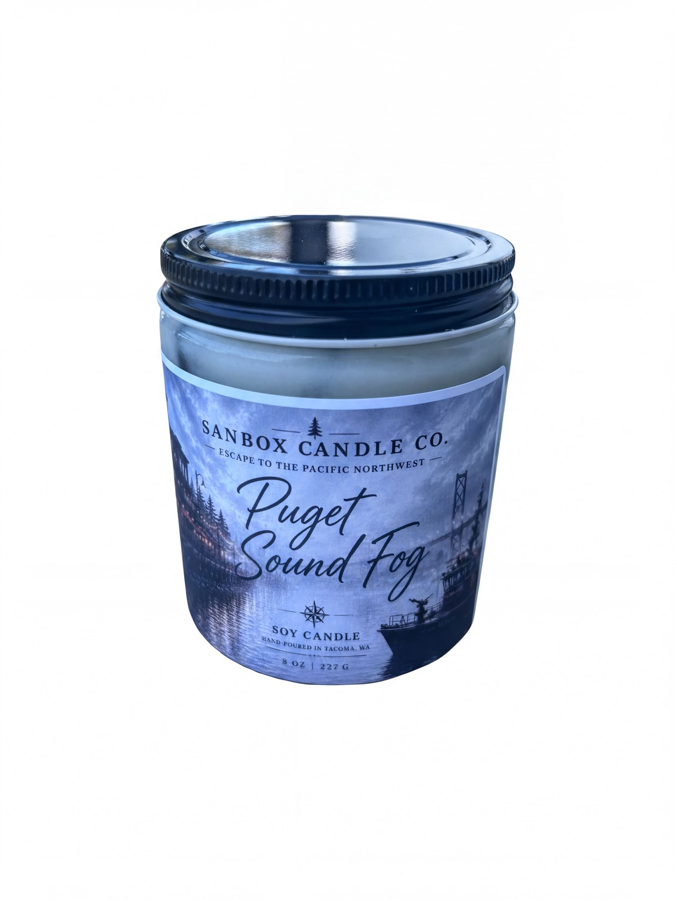 a candle in a jar with a label that reads "Puget Sound Fog".