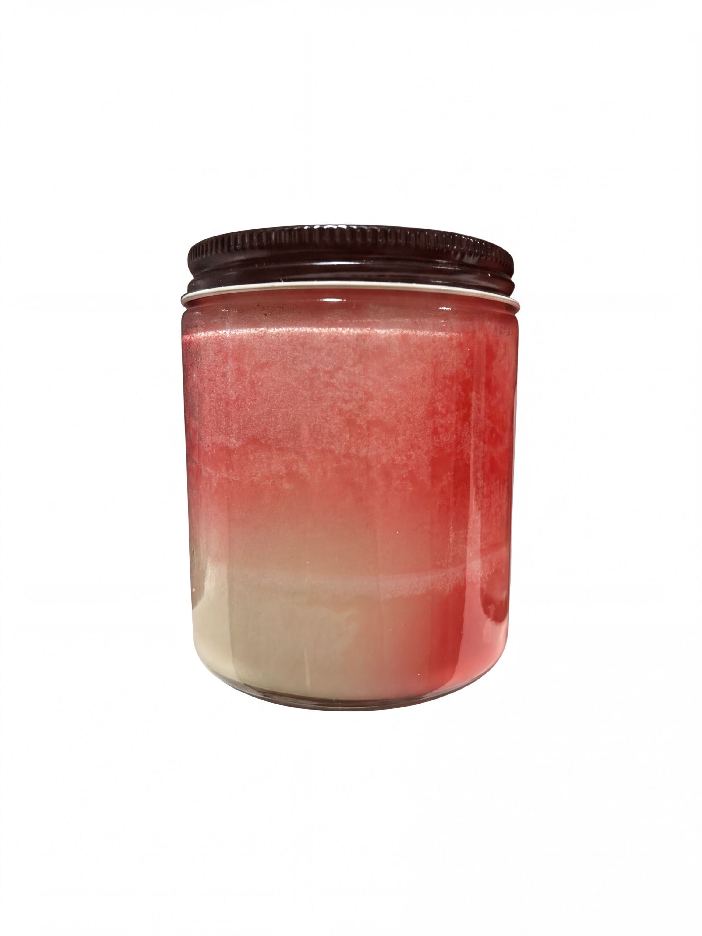 A glass jar with a black lid, containing a red and beige liquid, is shown against a white background.
