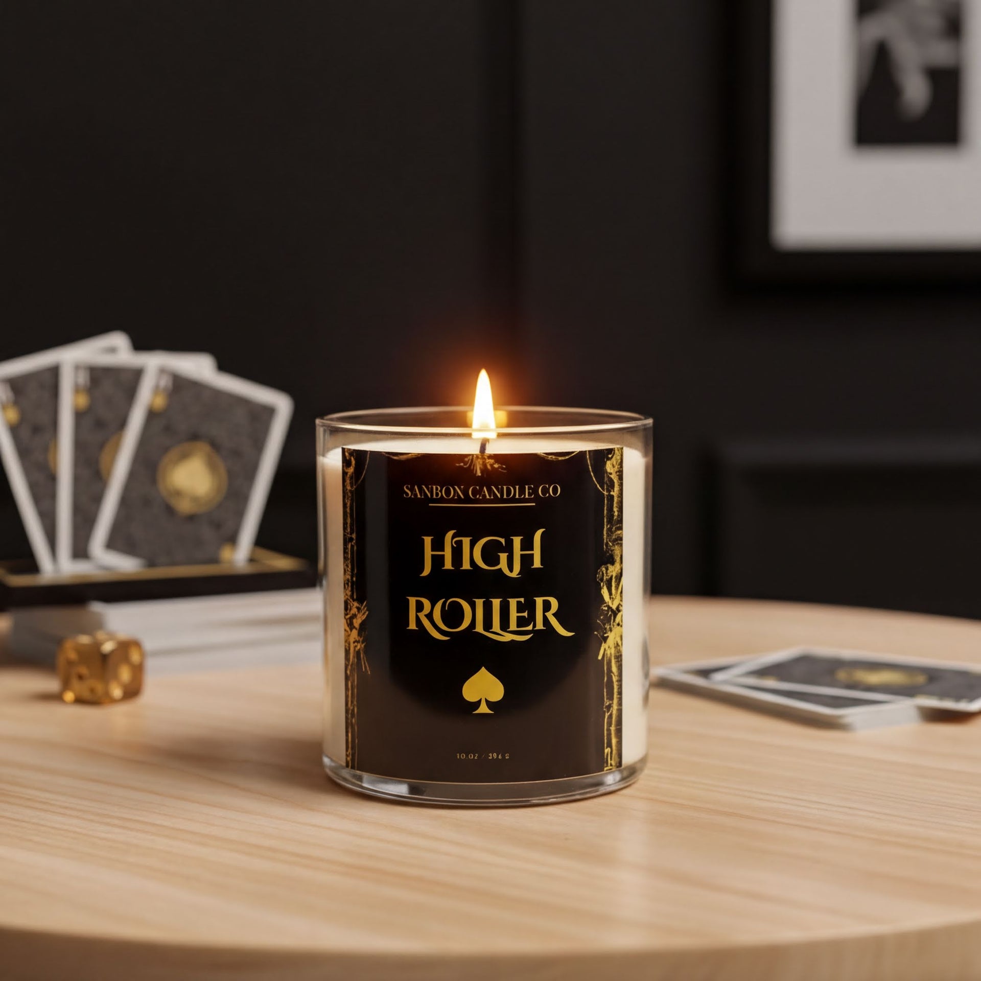 A lit candle labeled "High Roller" sits on a wooden table, with playing cards and a dice nearby.