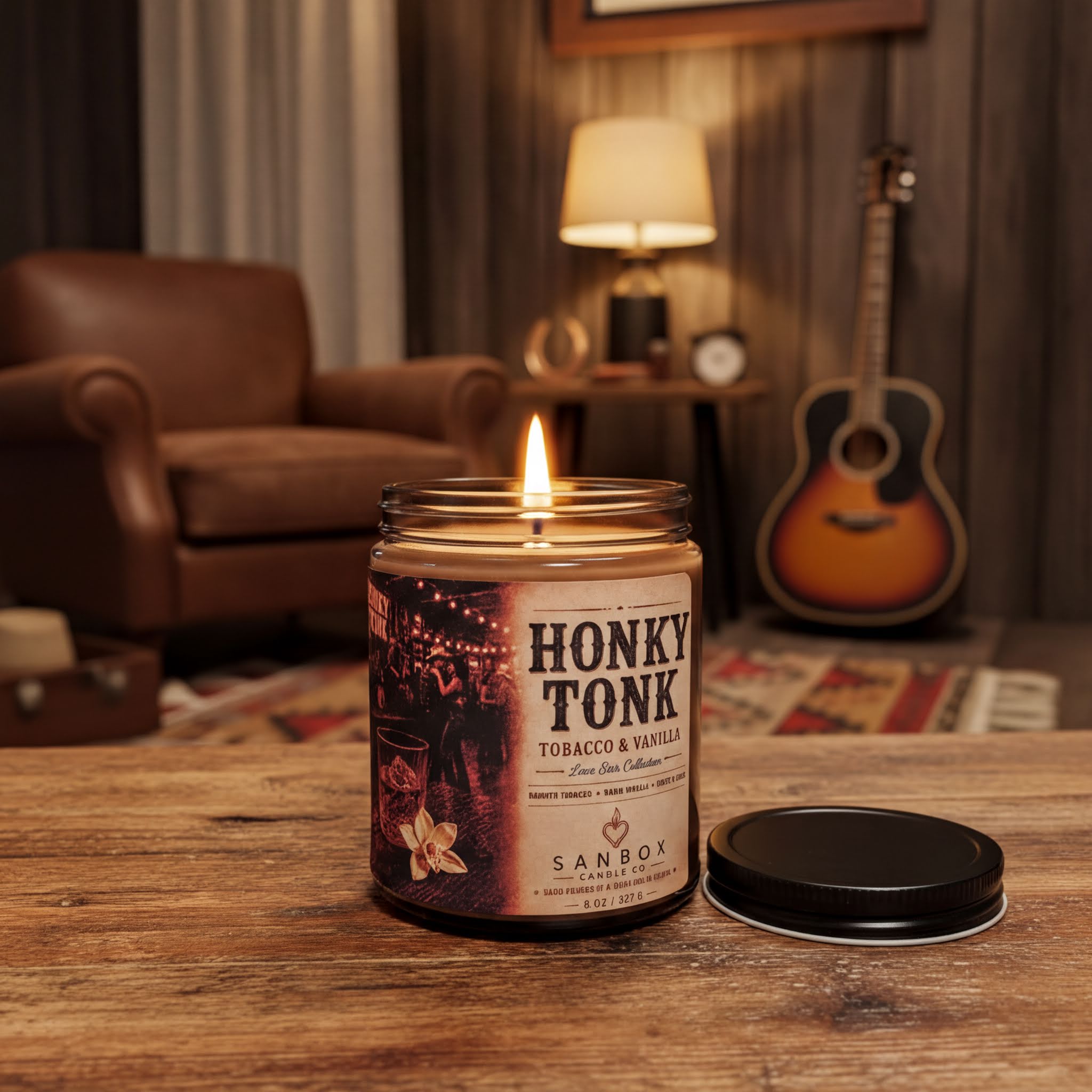 A lit candle in a jar sits on a wooden surface, with a guitar visible in the background.