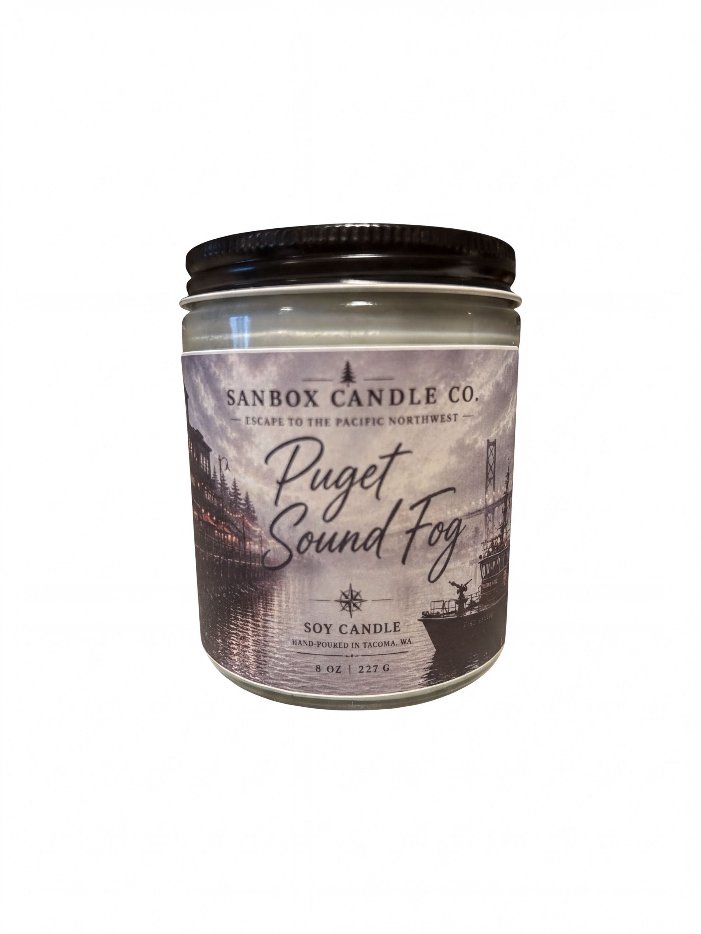 a soy candle in a jar with a label that reads "Puget Sound Fog".