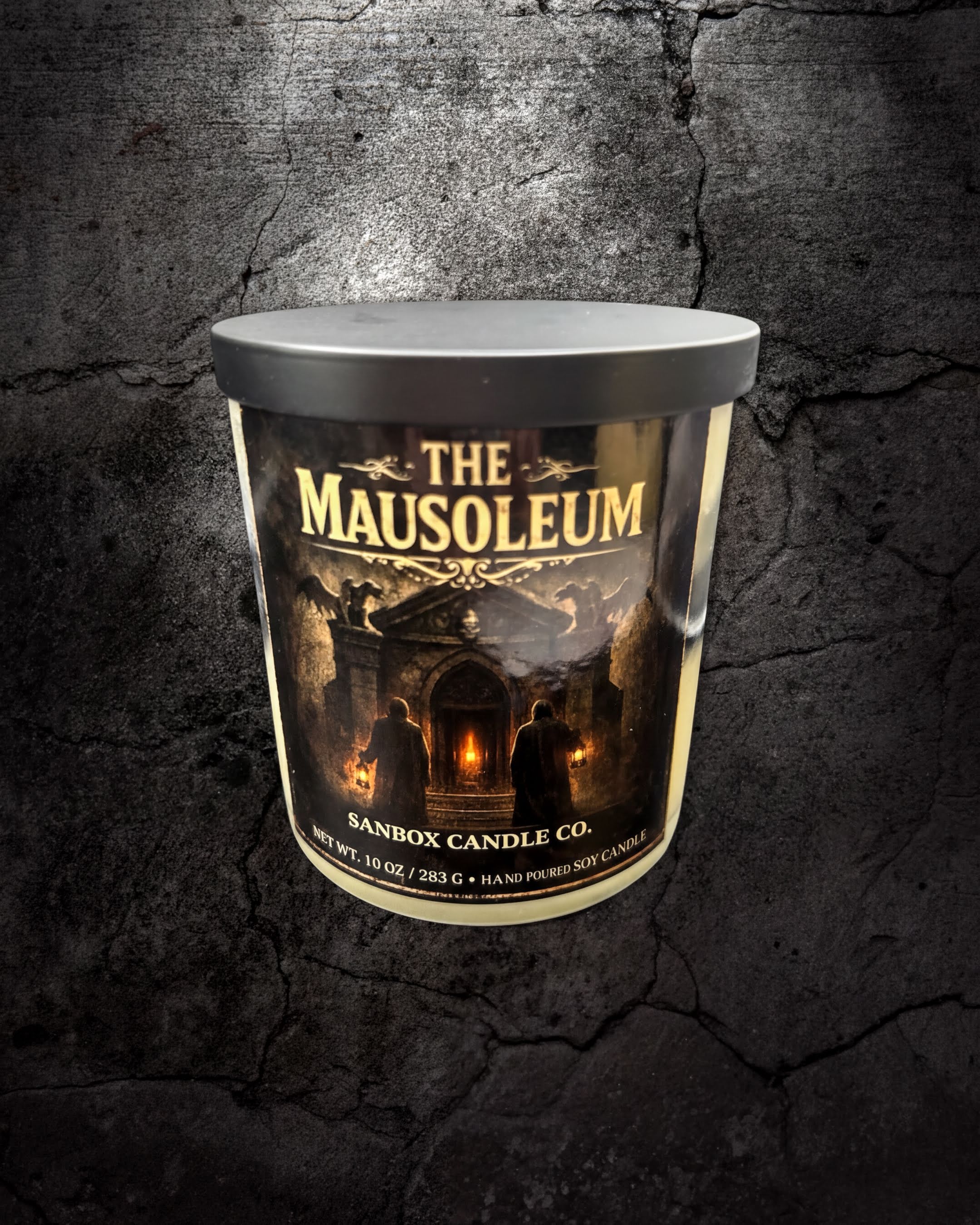 a cylindrical container with a label that reads "The Mausoleum" and "Banbox Candle Co."