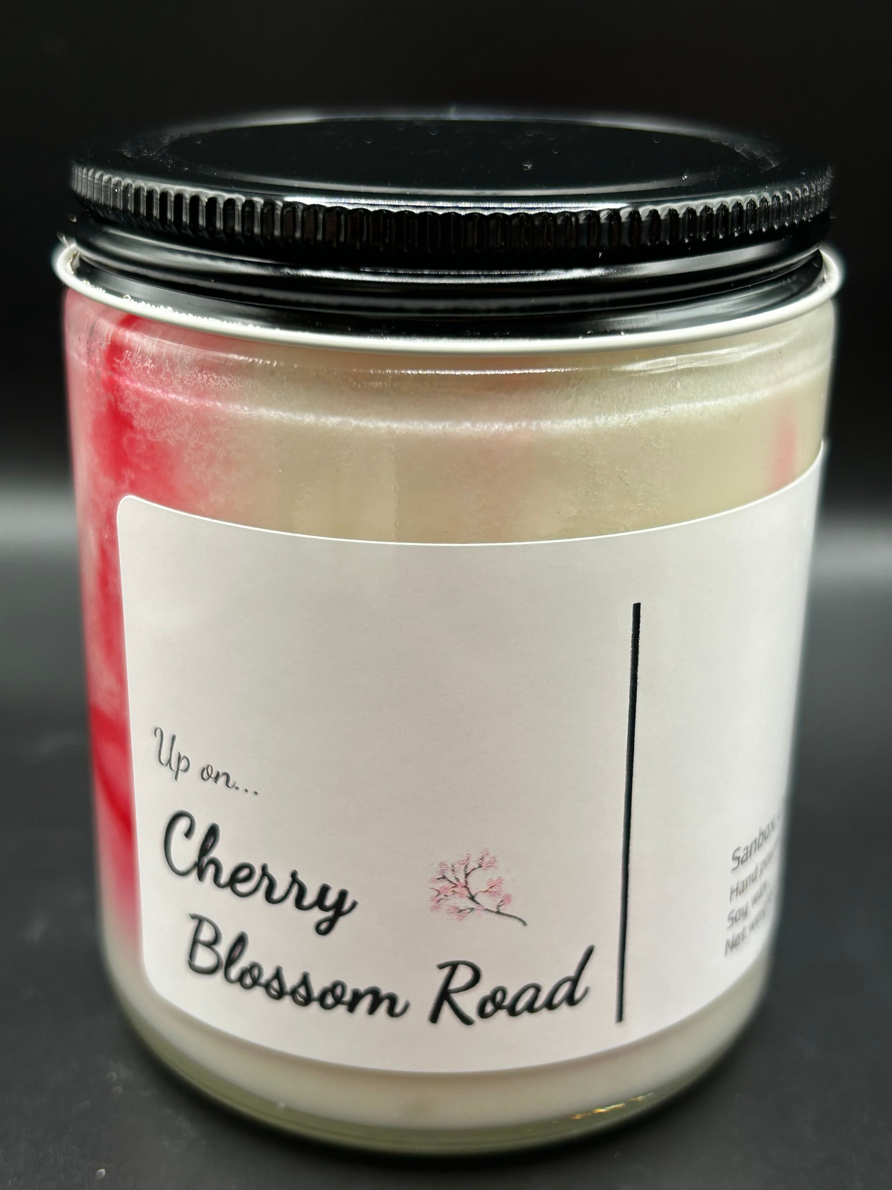 Cherry Blossom Road scented soy candle in glass jar with black lid and white label