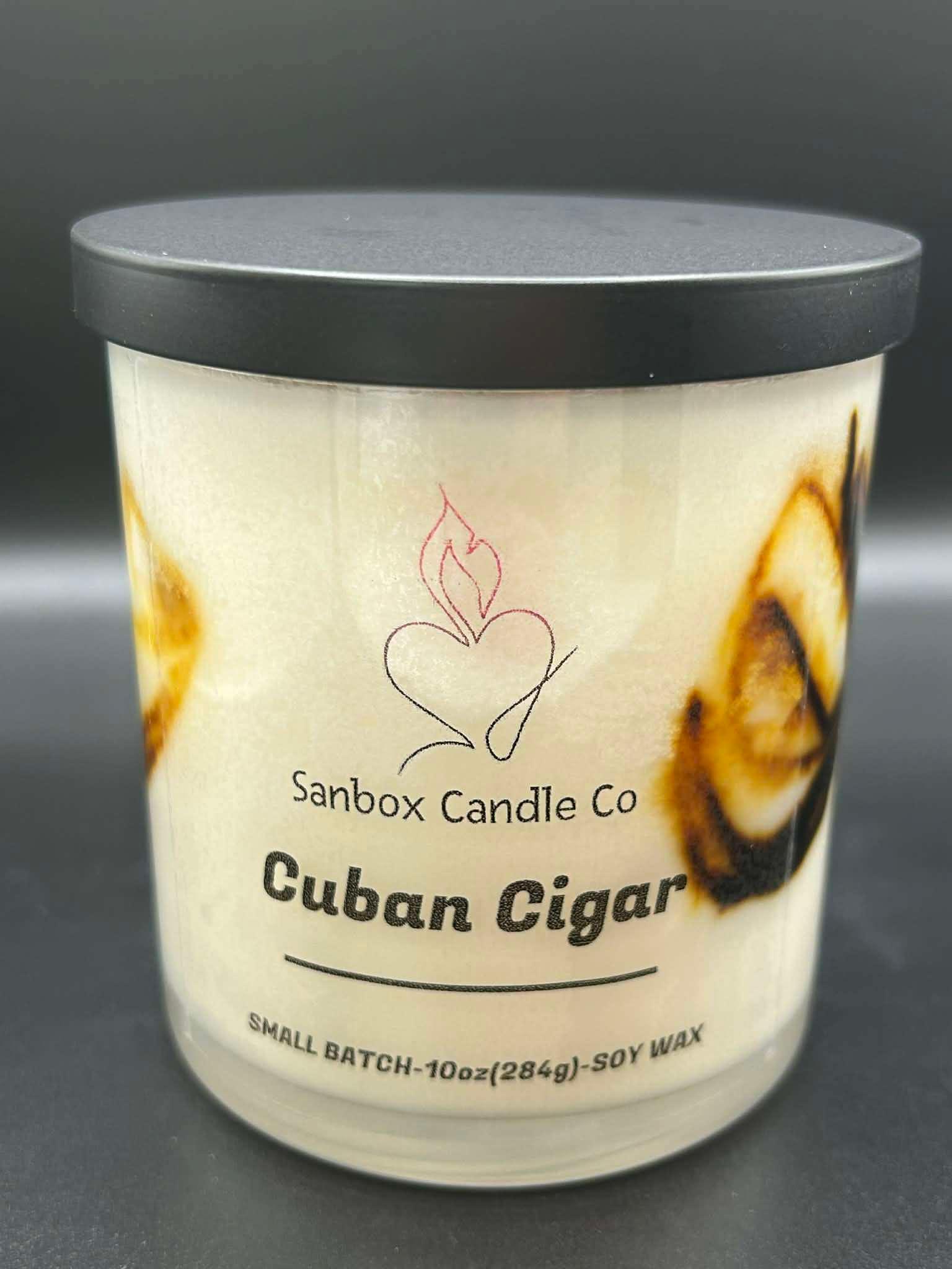 Cuban Cigar scented soy wax candle in glass jar with black lid, 10oz size, close up.