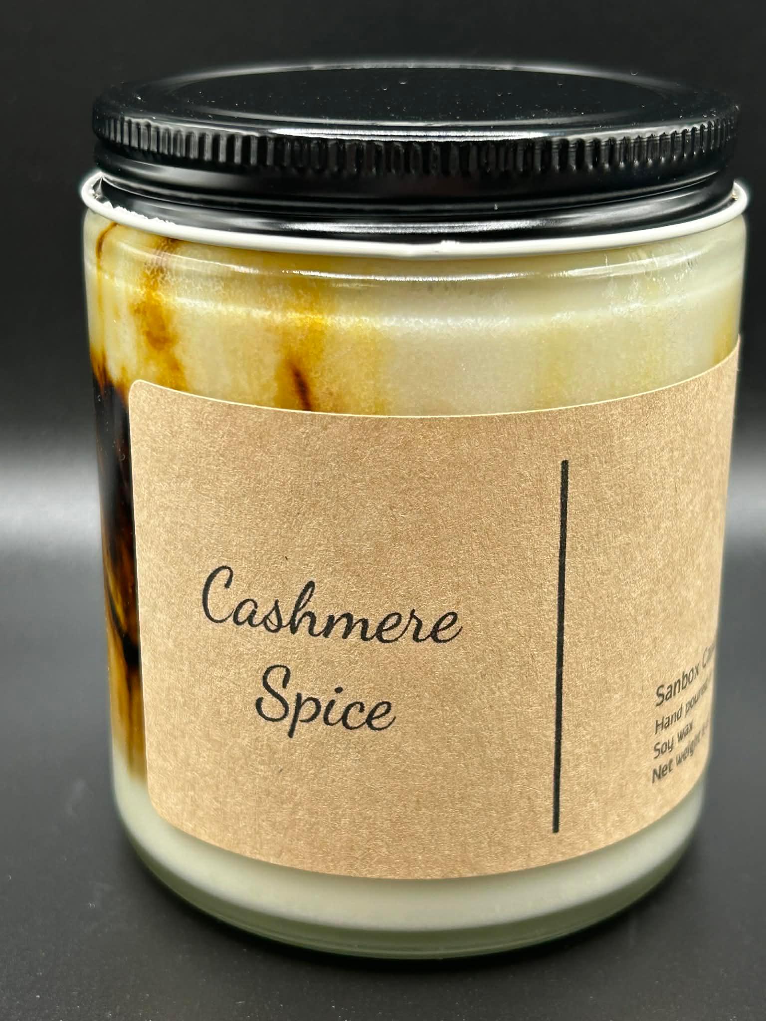 Cashmere Spice scented soy candle in glass jar with black lid and brown label