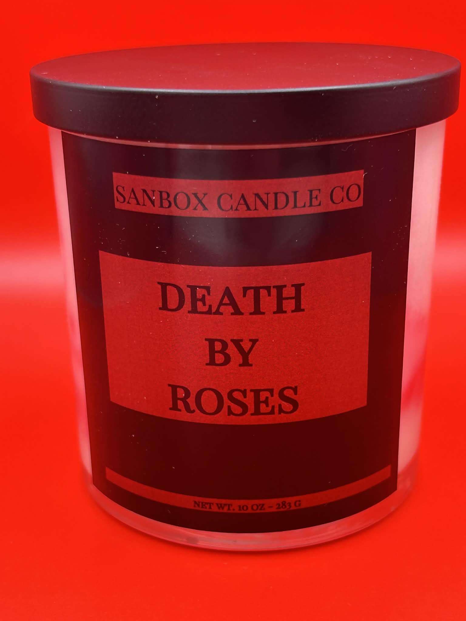 Death by Roses scented candle in black jar with red label, vivid red background