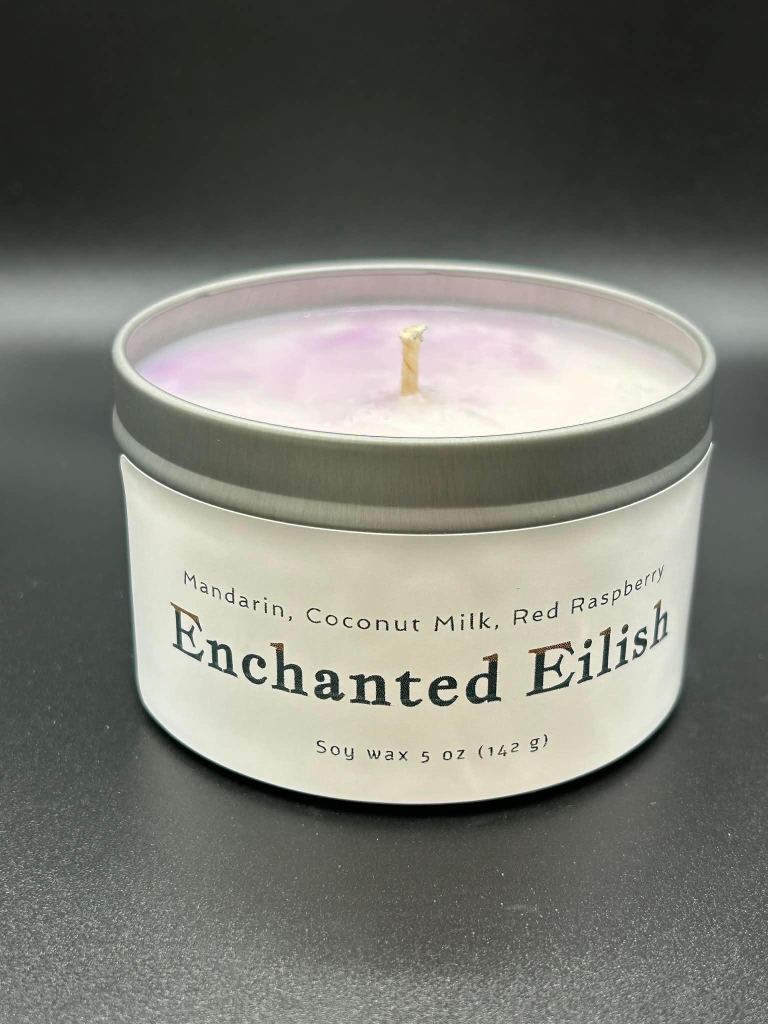 5oz soy wax candle labeled Enchanted Eilish, mandarin coconut milk red raspberry scent, in tin