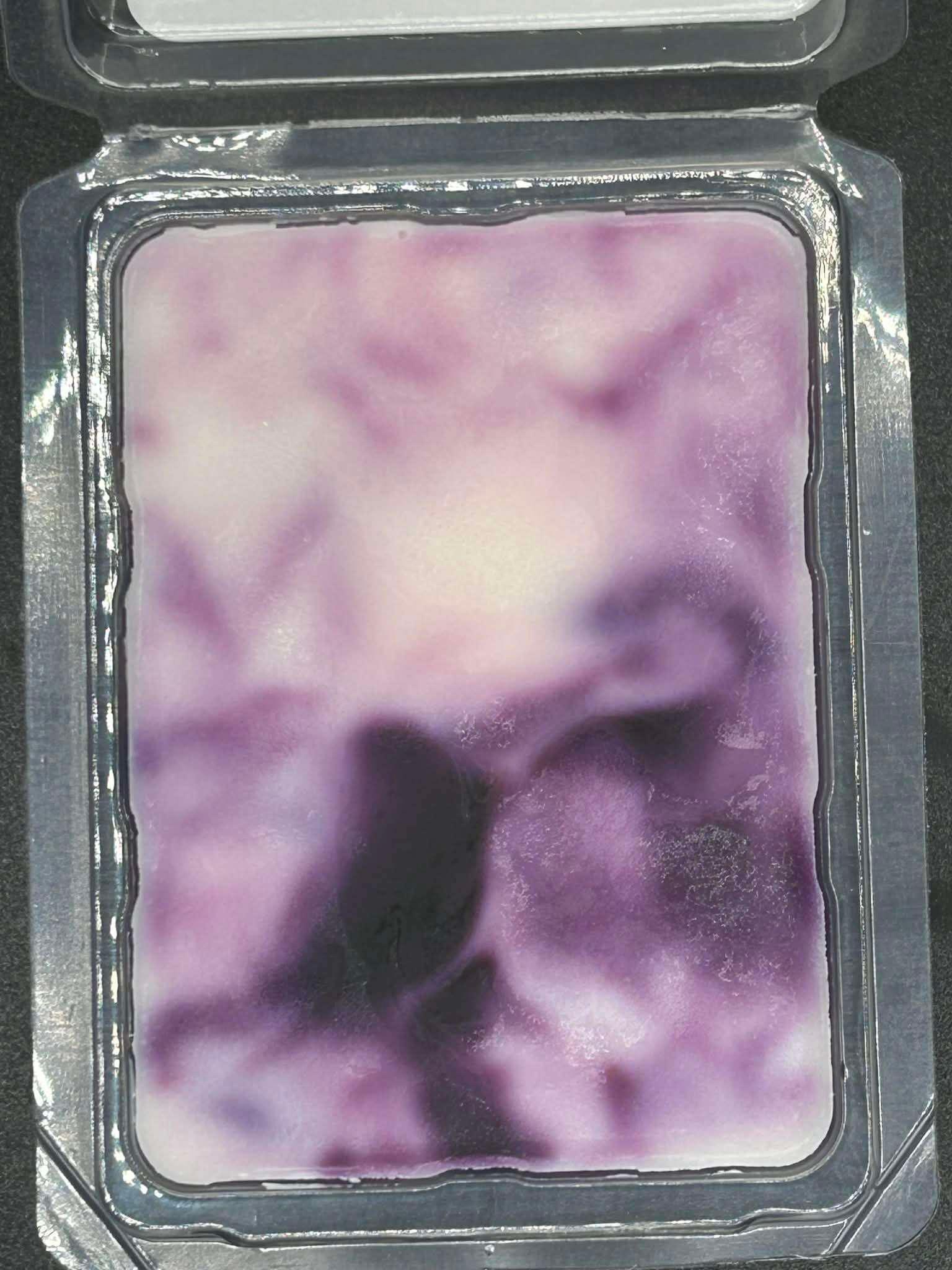 Purple marbled scented wax melt in clear plastic clamshell packaging