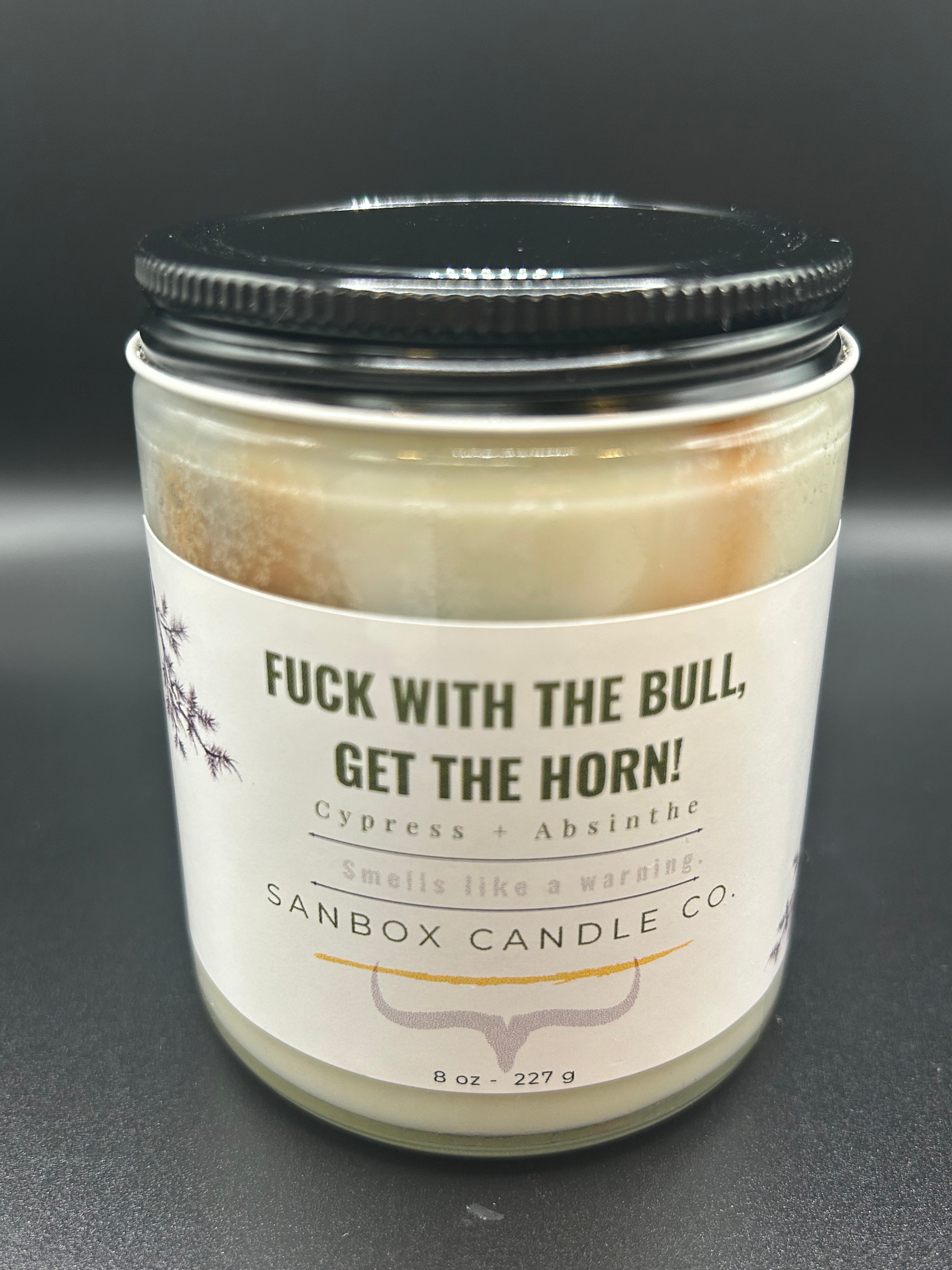 8oz scented candle with black lid, cypress absinthe label, bold warning text