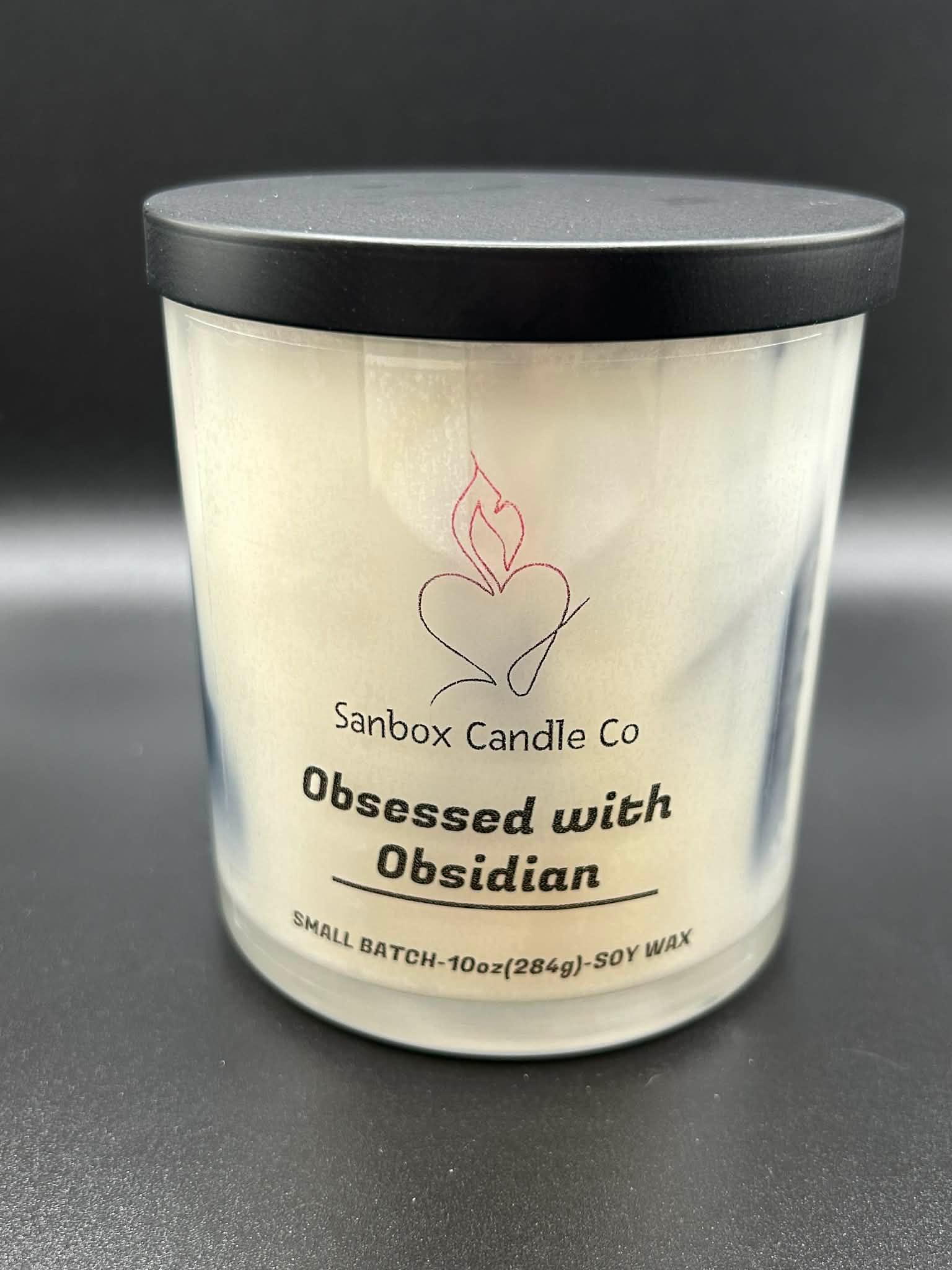 10oz soy wax candle with black lid labeled Obsessed with Obsidian on black background