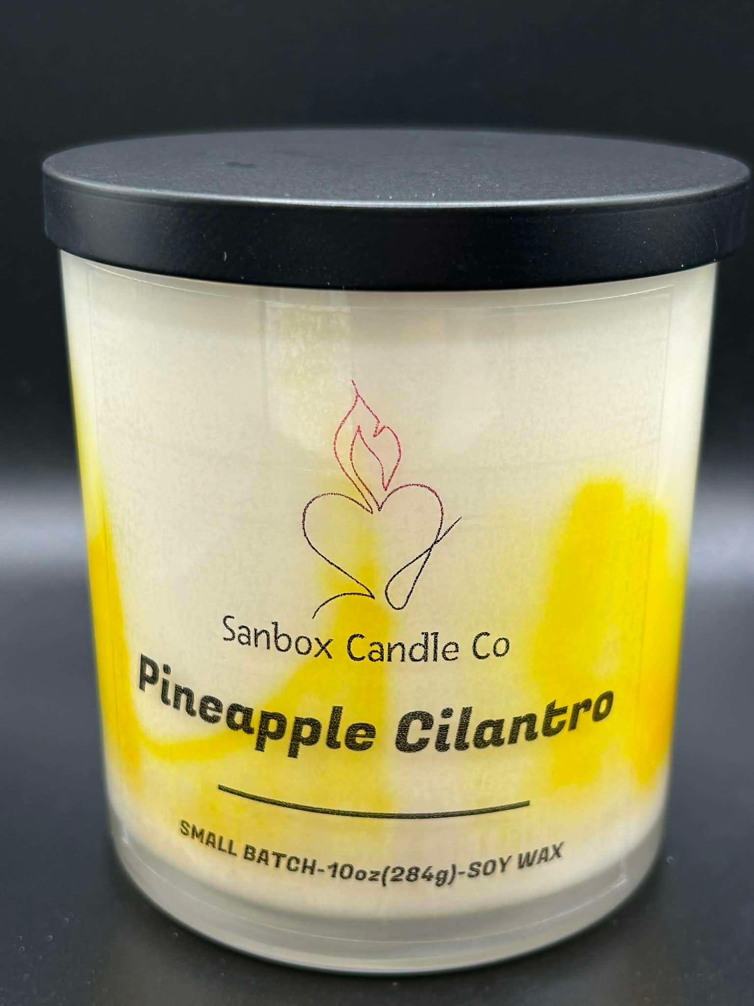 Pineapple Cilantro scented soy candle in a glass jar with black lid and yellow accents, 10oz