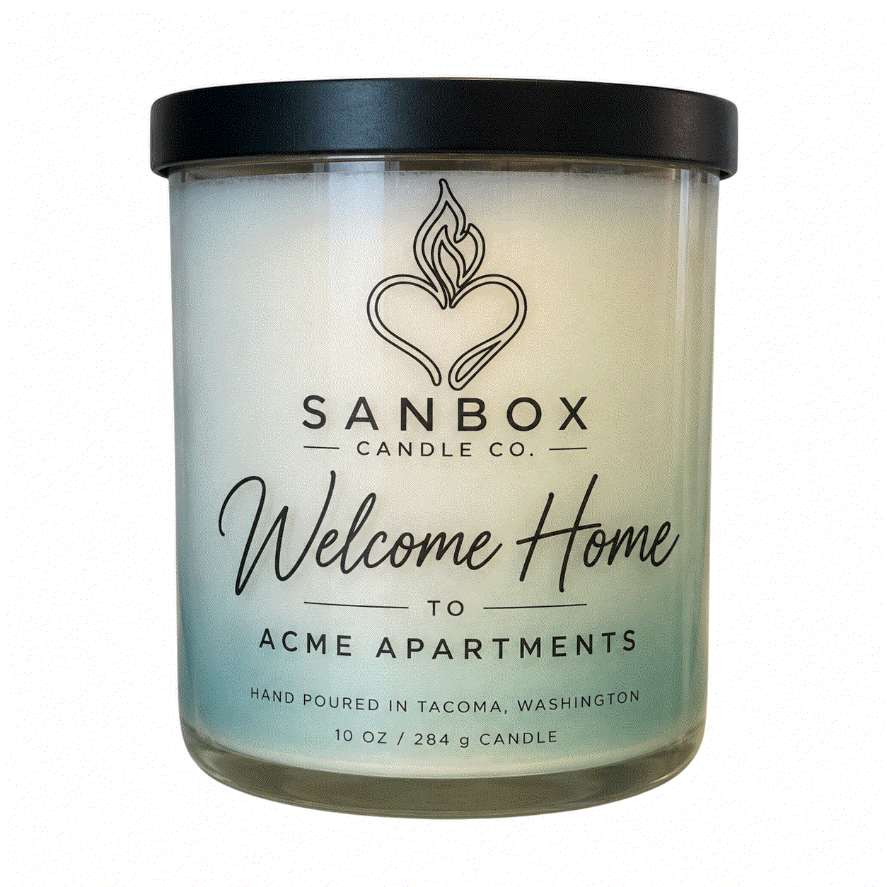 Welcome Home realtor gift candle in a clear glass jar with a matte black lid, cream soy wax with purple marbled design, styled on a marble side table.