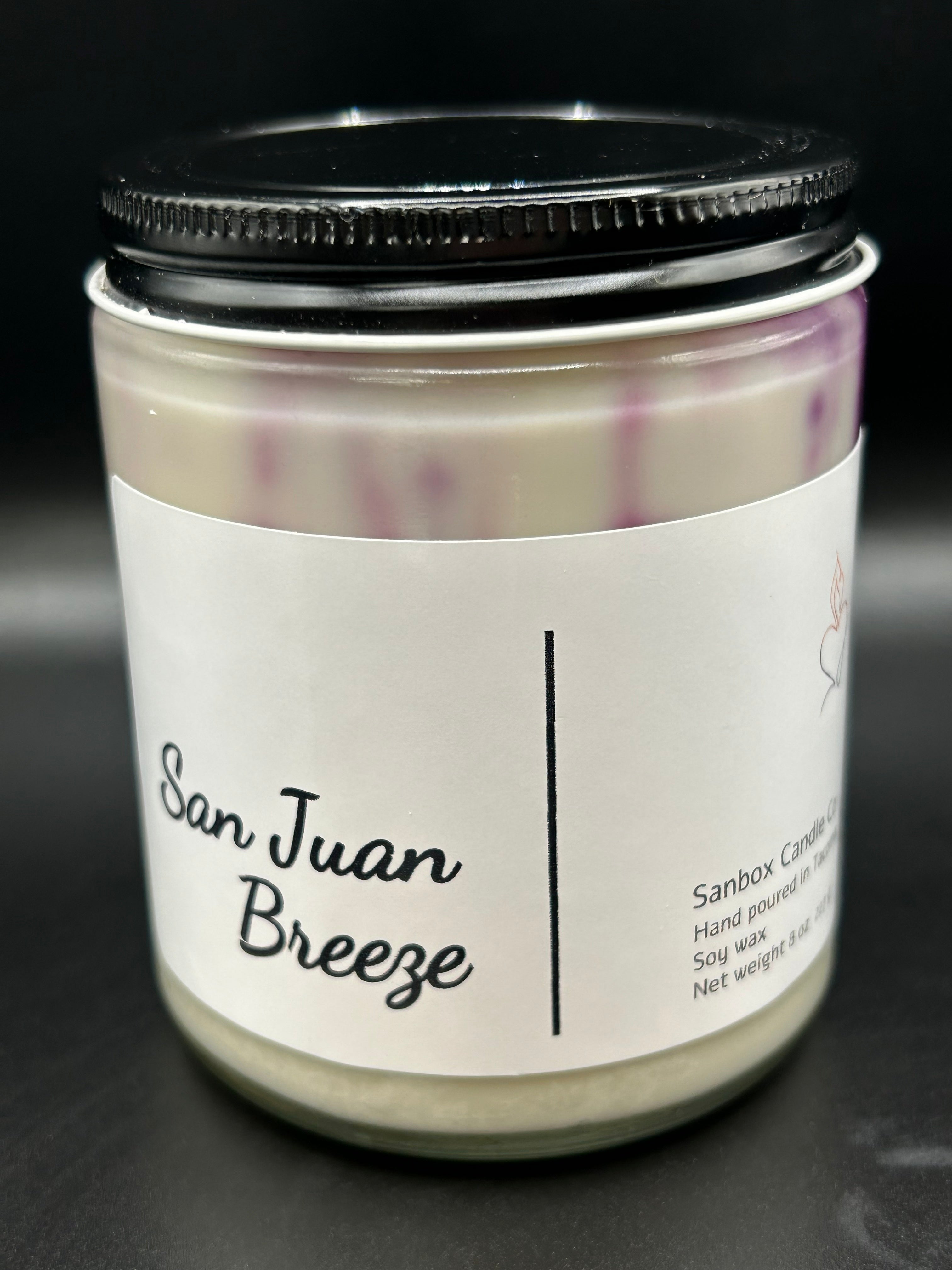 San Juan Breeze hand-poured soy candle in glass jar with black lid and white label