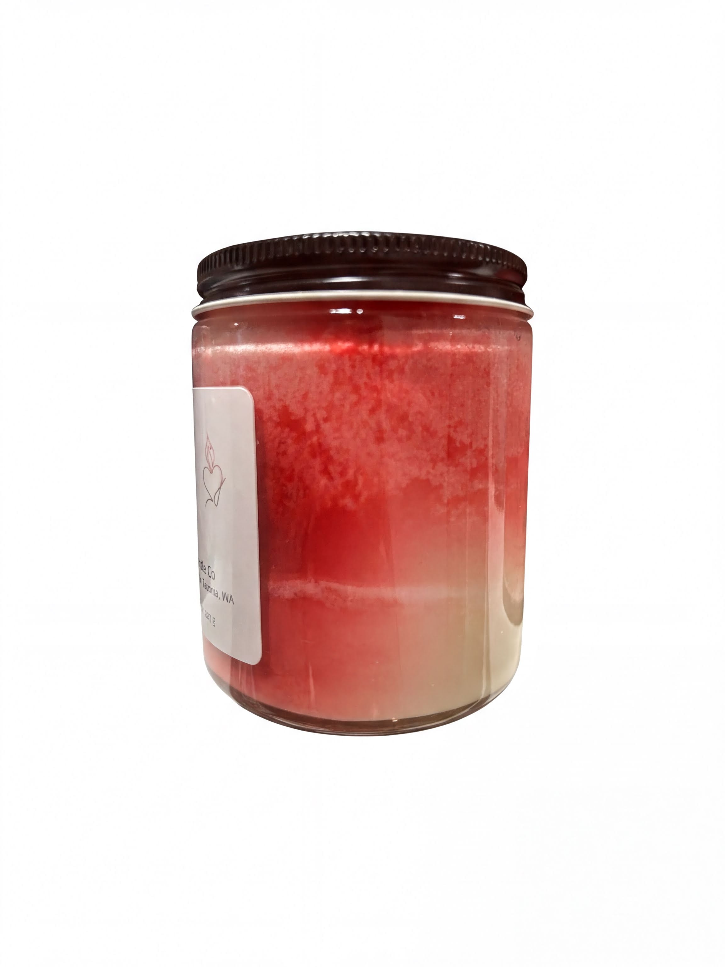 A glass jar with a black lid, containing a red substance, is shown against a white background.