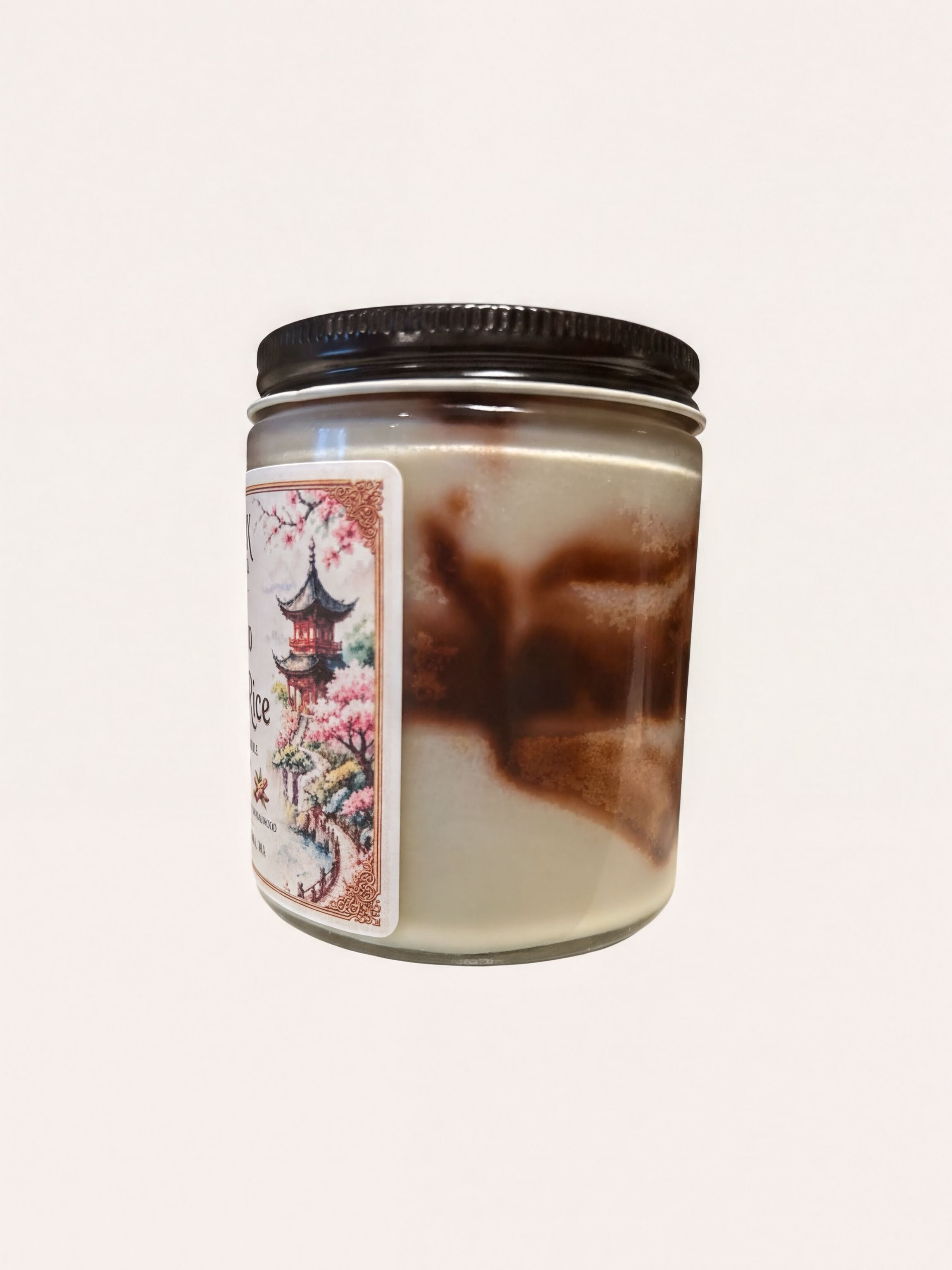 A jar with a black lid and a label featuring a floral design.