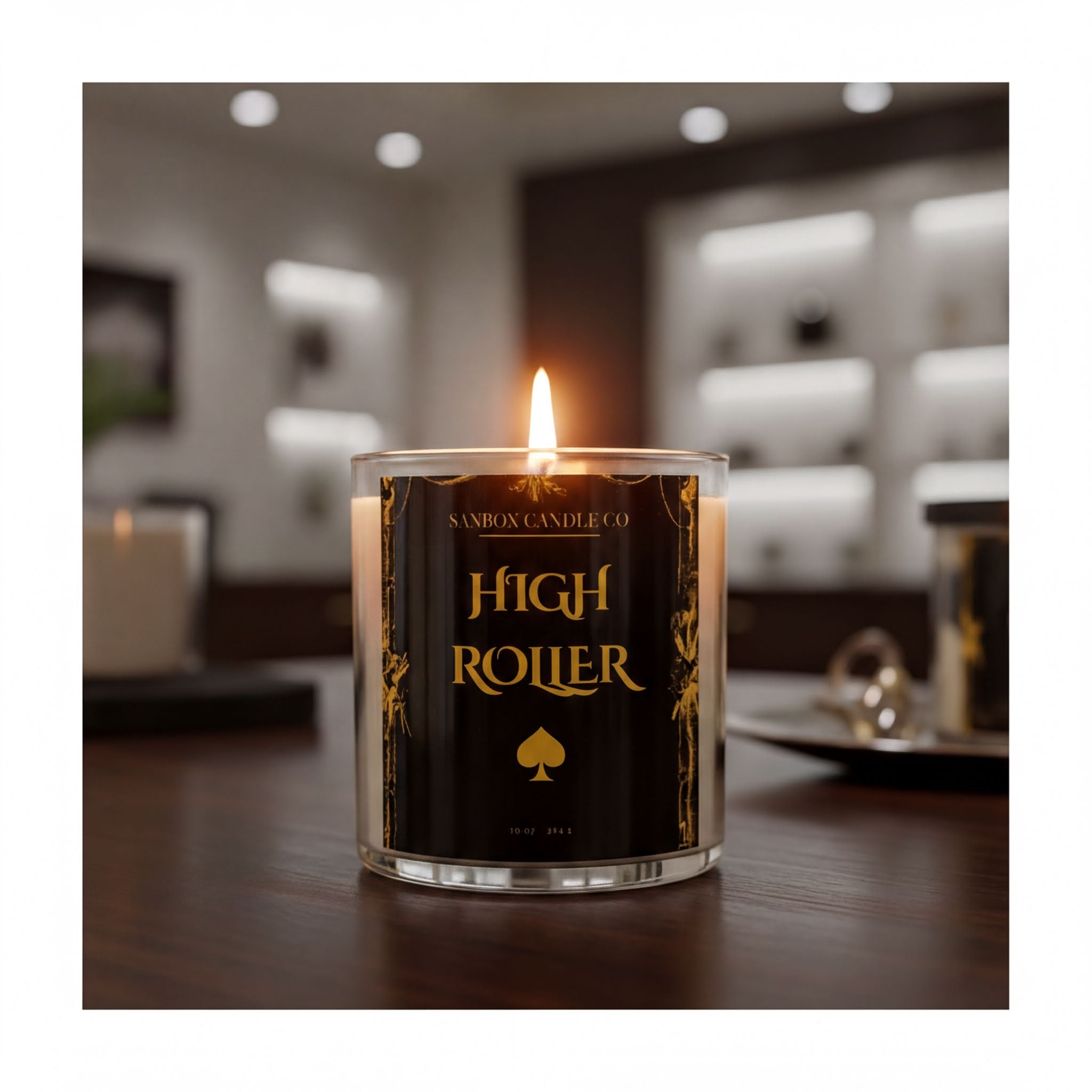 A lit candle labeled "High Roller" sits on a wooden surface, with a blurred background suggesting a room with shelves or cabinets.