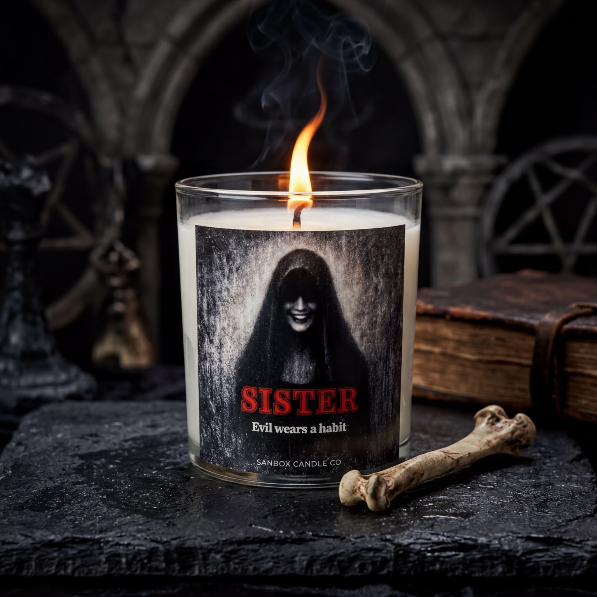 A lit candle with a label that reads "SISTER Evil wears a habit" is placed on a dark surface, with a bone and a book nearby.