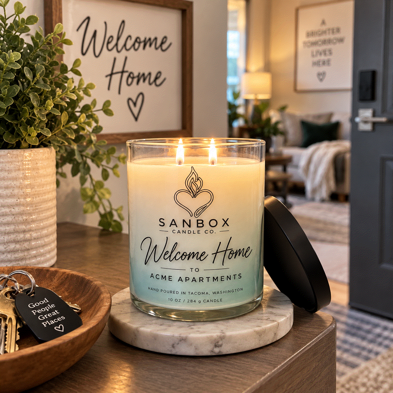 Welcome Home realtor gift candle in a clear glass jar with a matte black lid, cream soy wax with purple marbled design, styled on a marble side table.